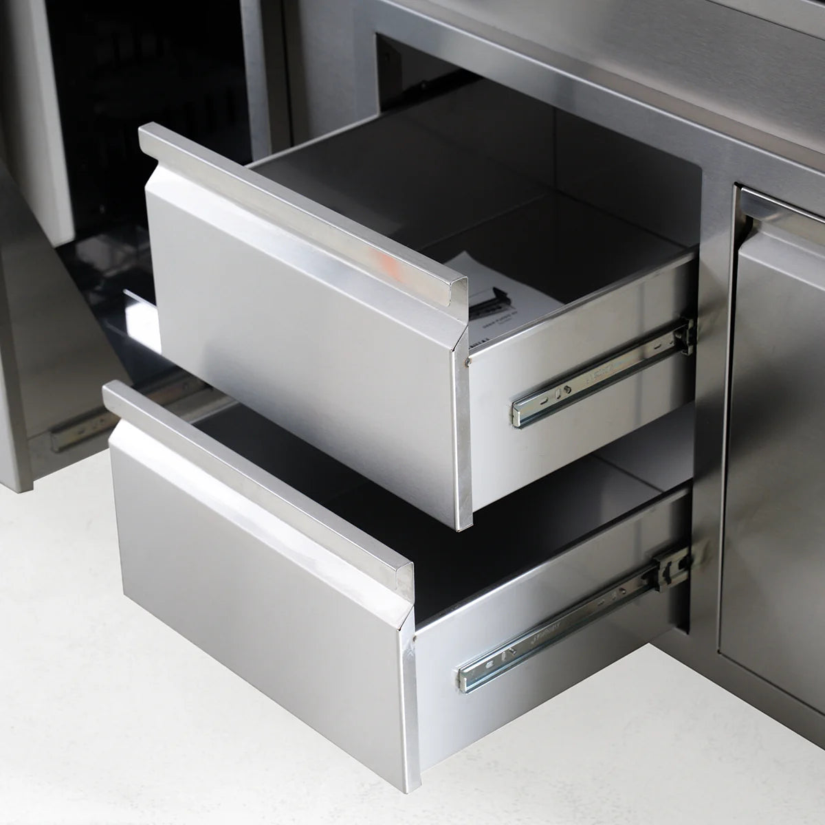 Stainless steel kitchen drawers with a modern design.