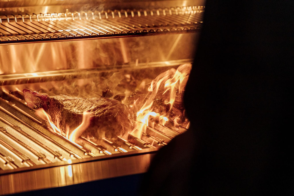 cooking steaks in an American Made Grills Encore grill