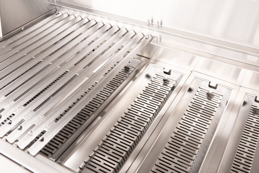 Close-up of stainless steel cooking grates and fuel trays inside an American Made Grills Muscle grill