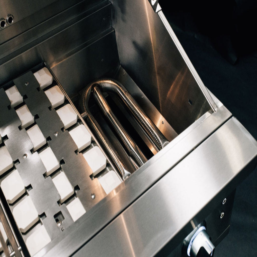 Summerset Quest grill interior showing ceramic briquettes and stainless steel U-tube burner